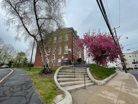 an old brick building on the corner of a street with stairs